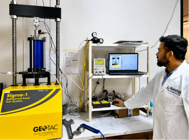 Quartet Engineers Corporations very own Lab technician performing Advanced Load Test on geotechnical soil samples for bearing capacity